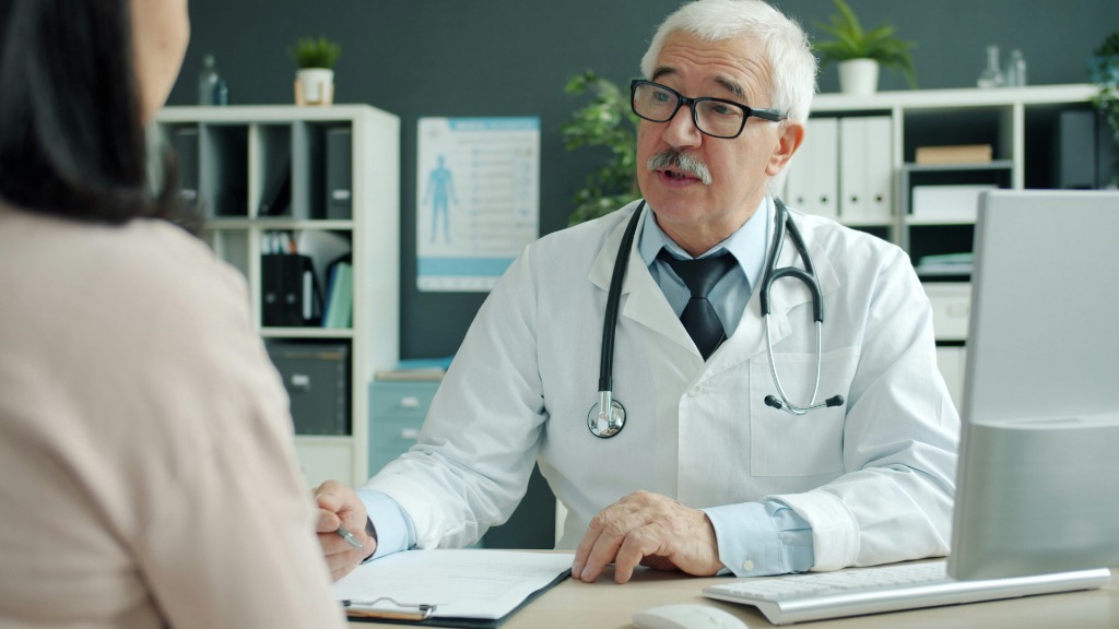 Clinician in consultation with a patient.